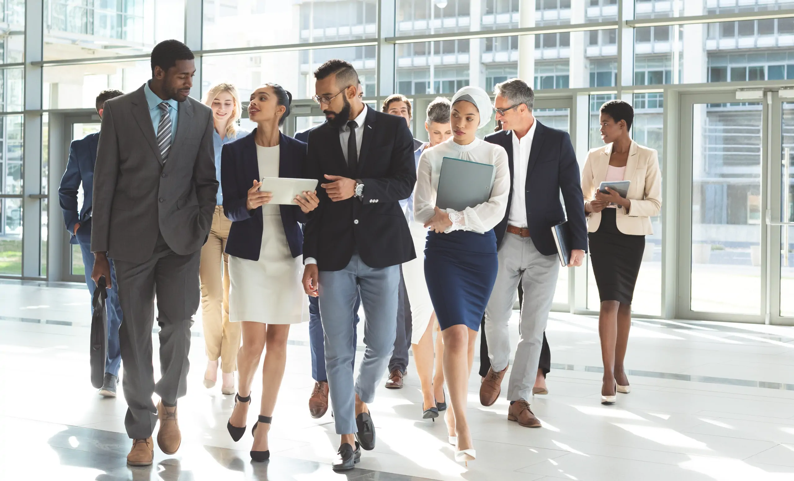 A team of business people walking and smiling together.