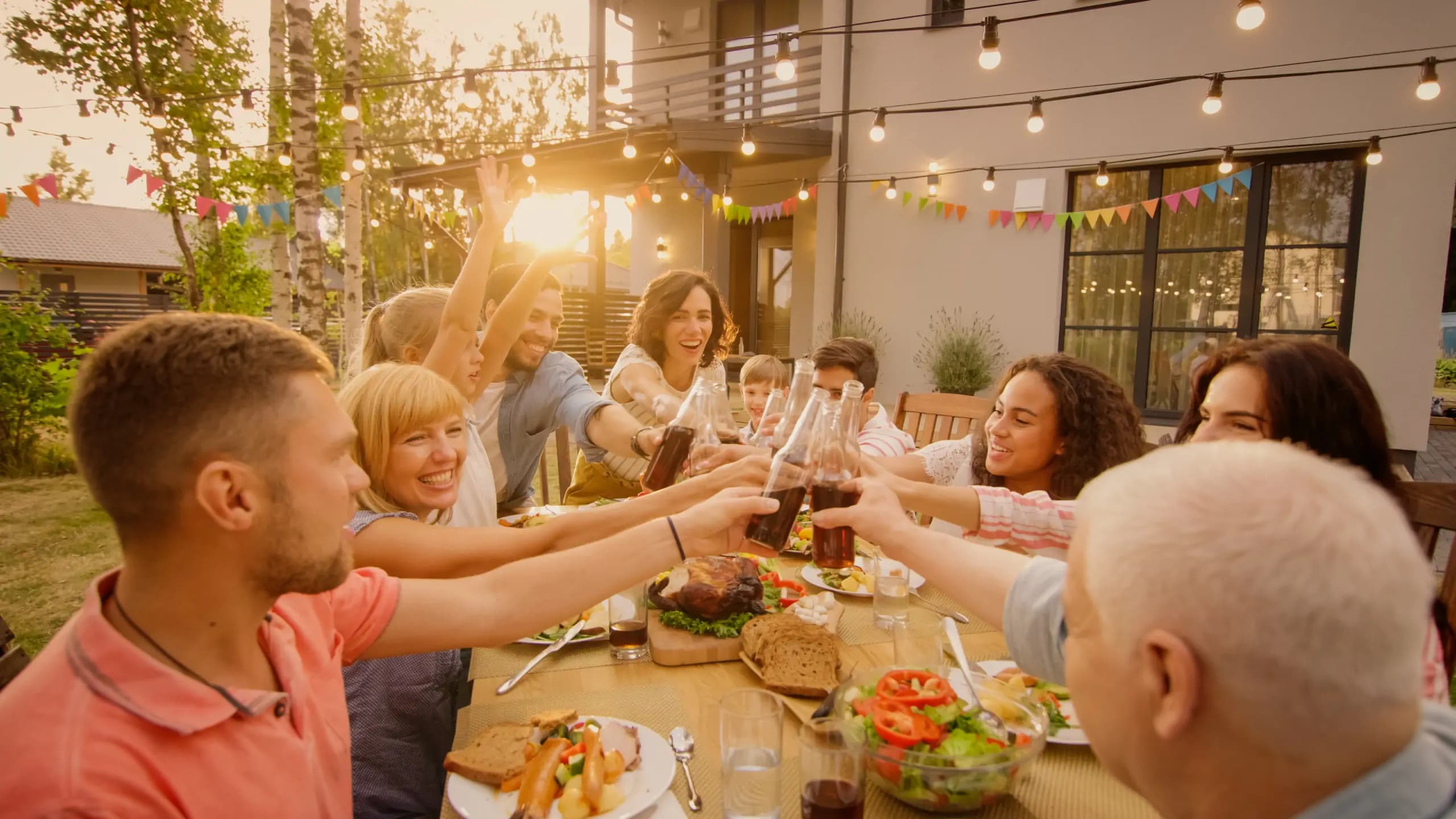 Family having dinner together outside. Smiling and laughing.